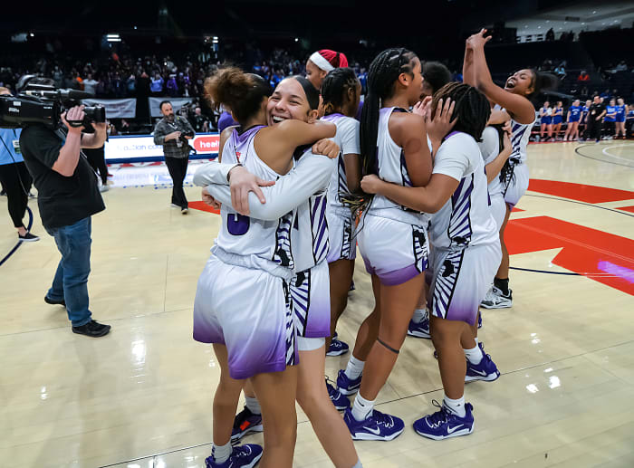 Africentric girls basketball players celebrate winning the 2023 Division III state championship.